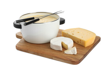 Fondue with tasty melted cheese, forks and pieces isolated on white