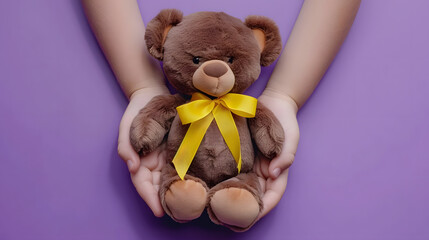 Hands holding children soft toy brown bear with yellow gold ribbon on purple background Childhood cancer awareness World Suicide Prevention Day September yellow : Generative AI - Powered by Adobe