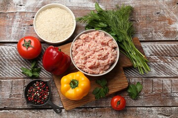 Making stuffed peppers. Ground meat and other ingredients on wooden table, flat lay