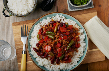 Flat lay of Mexican styled chilli with white rice.