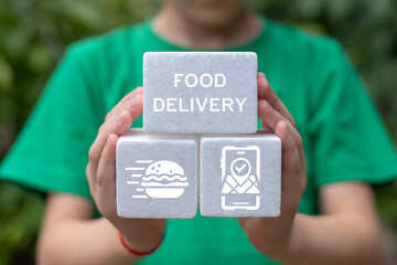 Little girl holding white styrofoam blocks sees inscription: FOOD DELIVERY. Concept of online food delivery service. Fast contactless food delivery school and home.