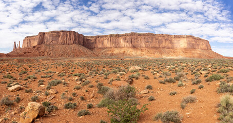Panorama of Three Sisters formation and  large mesa from the valley floor in Monument Valley,...