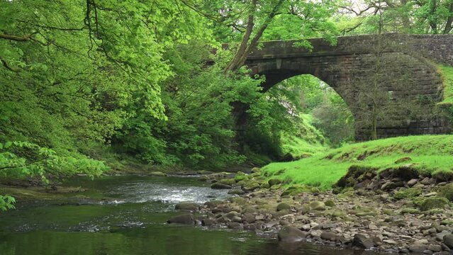 Slow motion footage of the River Dane flowing through Danebridge in the Peak District National Park.