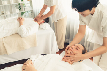 Caucasian couple enjoying relaxing anti-stress head massage and pampering facial beauty skin...