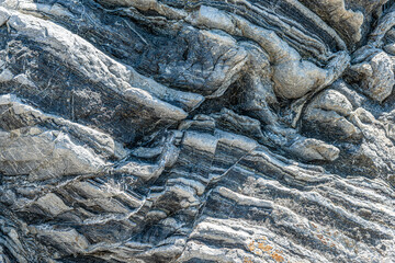 Nature force compressed prominent cracked rock layers structure formation details, in various...