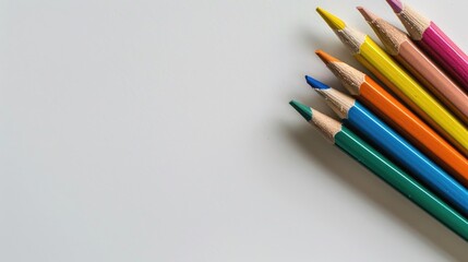Colored pencils set on a plain white background with space for text