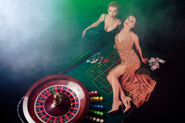 Top photo of tempting hot vip girls enjoy holiday in casino club playing poker winning black jack...
