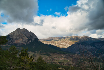 The Pedraforca is an emblematic mountain of Catalonia located in the Cadi mountain range. A mountain that has two peaks separated by a large col.  Vertical photo of landscape and background in autumn.