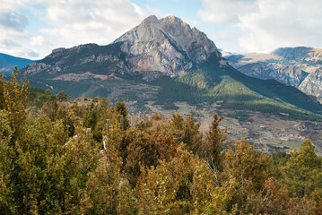 Fototapeta premium The Pedraforca is an emblematic mountain of Catalonia located in the Cadi mountain range. A mountain that has two peaks separated by a large col. Vertical photo of landscape and background in autumn.