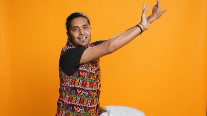 Joyful person having fun, dancing on rhythm, enjoying days off from work. Upbeat indian man...