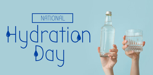 Female hands with bottle and glass of cold water on blue background
