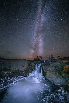 Orchon waterfall at night with starry sky and Milky Way, Uvurkhangai Province, Mongolia, Asia