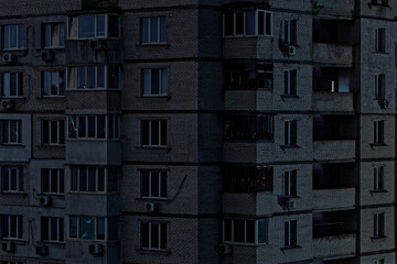 View on a panel residential building during blackout of electricity at night. Apartment...