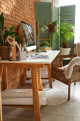 Modern workplace with computer and green plants in office