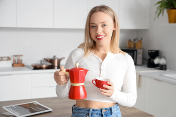 Pretty young woman with cup of espresso and geyser coffee maker in modern kitchen