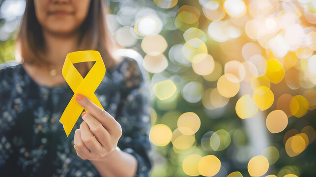 happy woman holding yellow ribbon september suicide prevention day childhood sarcoma bone and bladder cancer Awareness month health care support people and world cancer day concept : Generative AI