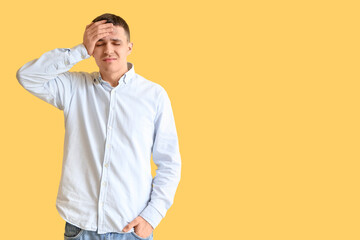 Young man with brain concussion on yellow background