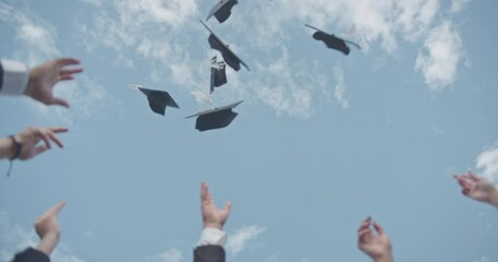 In a celebratory moment, graduates joyfully toss their caps into the air, symbolizing both achievement and the exciting start of a new journey.