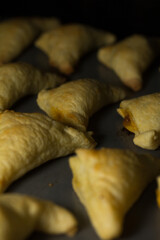 Photograph of empanadas baking. 