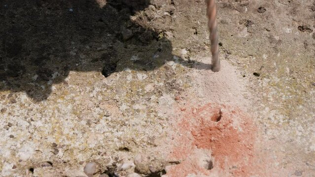 Close up of hammer action SDS drill drilling holes in concrete block