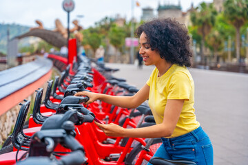 Woman using bike public sharing system in the city