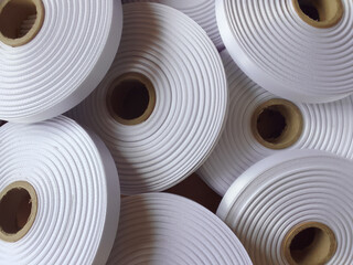 rolls of white ribbon. thick satin ribbon with a rough and striped texture
