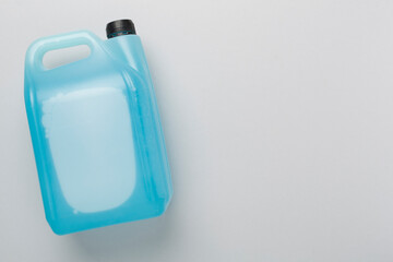Can with antifreeze on color background, top view