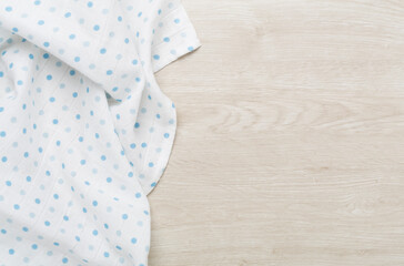 Cotton fabric on wooden background, top view