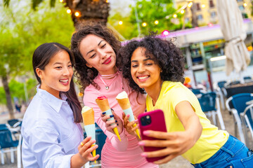 Friends taking selfie enjoying an ice cream during holidays