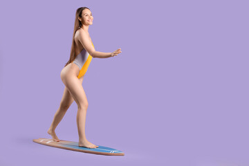 Smiling woman on surfboard against purple background