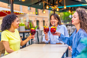 Friends drinking cocktails in an outdoor terrace