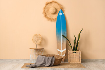 Surfboard with baskets and table near beige wall in room