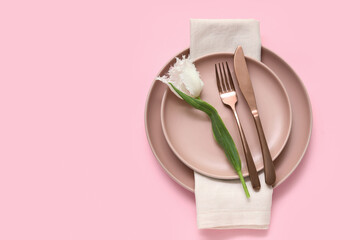 Stylish table setting with beautiful tulip on pink background