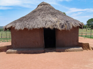 traditional african hut, rondavel with thatched roof and mud clay walls