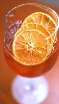 Vertical video of premium cocktails on wooden table. Slow motion cocktail videos. Concept of mixology and cocktails.
