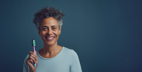 Mockup Beautiful Smiling With White Teeth Woman In Her 50s Holding Toothbrush On Blue Background, Copy Space. Dental Hygiene, Health. Ai Generated. Horizontal. Hispanic, Latino Middle Aged Female