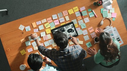 Top view of creative designer working together brainstorming idea by using sticky notes at meeting...