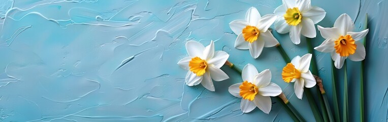 Easter Blessings: Daffodil Panorama on Turquoise Paper Background - Holiday Greeting Card or Banner with Table Top View