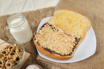 Bread with peanut, chocolate and butter spread on a table for breakfast	
