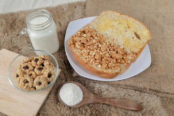 Bread with peanut and butter spread on a table for breakfast
