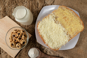 Bread with cheese, sweetened condensed milk, and butter. With white milk and snack on a table for breakfast	

