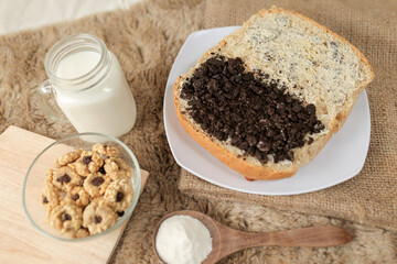 Bread with chocolate cookies oreo cheese and butter spread on a plate for breakfast	
