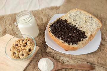 Bread with chocolate cookies oreo cheese and butter spread on a plate for breakfast	
