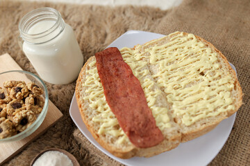 Bread with smoked beef on a plate for breakfast and coffee break