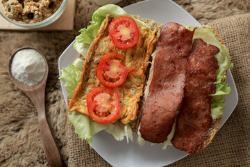 Big breakfast, bread, chicken slice, tomato, lettuce, smoked beef, egg, salad with milk. Bread sandwich fresh and healthy food meal lunch dinner breakfast slices of sandwiches.