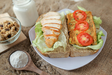 Big breakfast, bread, chicken slice, tomato, lettuce, smoked beef, egg, salad with milk. Bread sandwich fresh and healthy food meal lunch dinner breakfast slices of sandwiches.