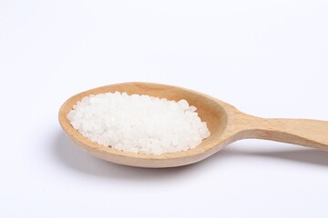 Natural salt in wooden spoon on white background