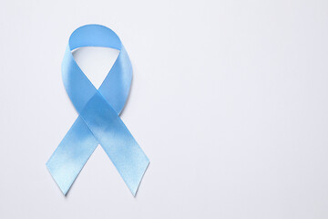 International Psoriasis Day. Light blue ribbon as symbol of support on white background, top view....