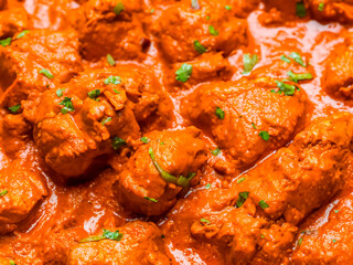 chicken tikka masala with rice and curry in a bowl