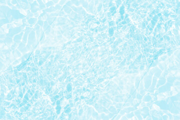 Blue water with ripples on the surface. Defocus blurred transparent blue colored clear calm water surface texture with splashes and bubbles. Water waves with shining pattern texture background.